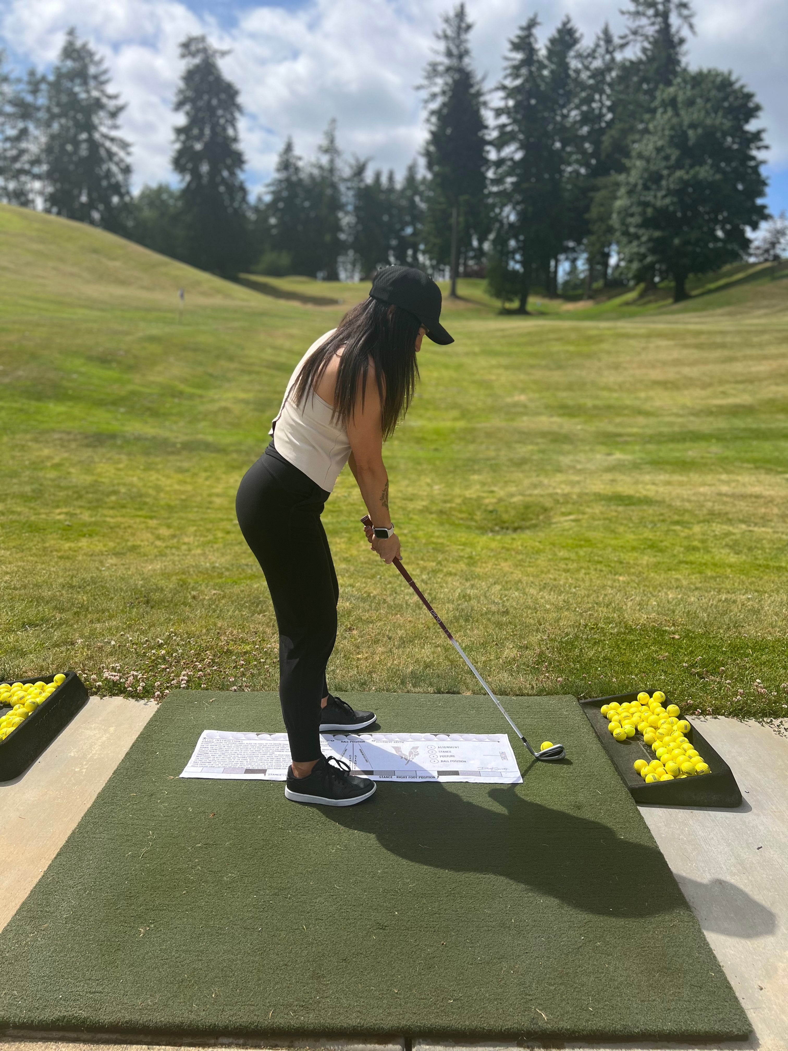 Ashley Quinn using the Savvy Setup Golf Towel on the range